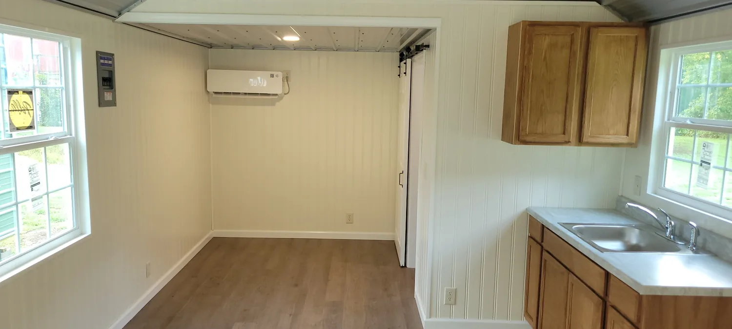 Basecamp Blue wide interior with sleeping area and kitchen