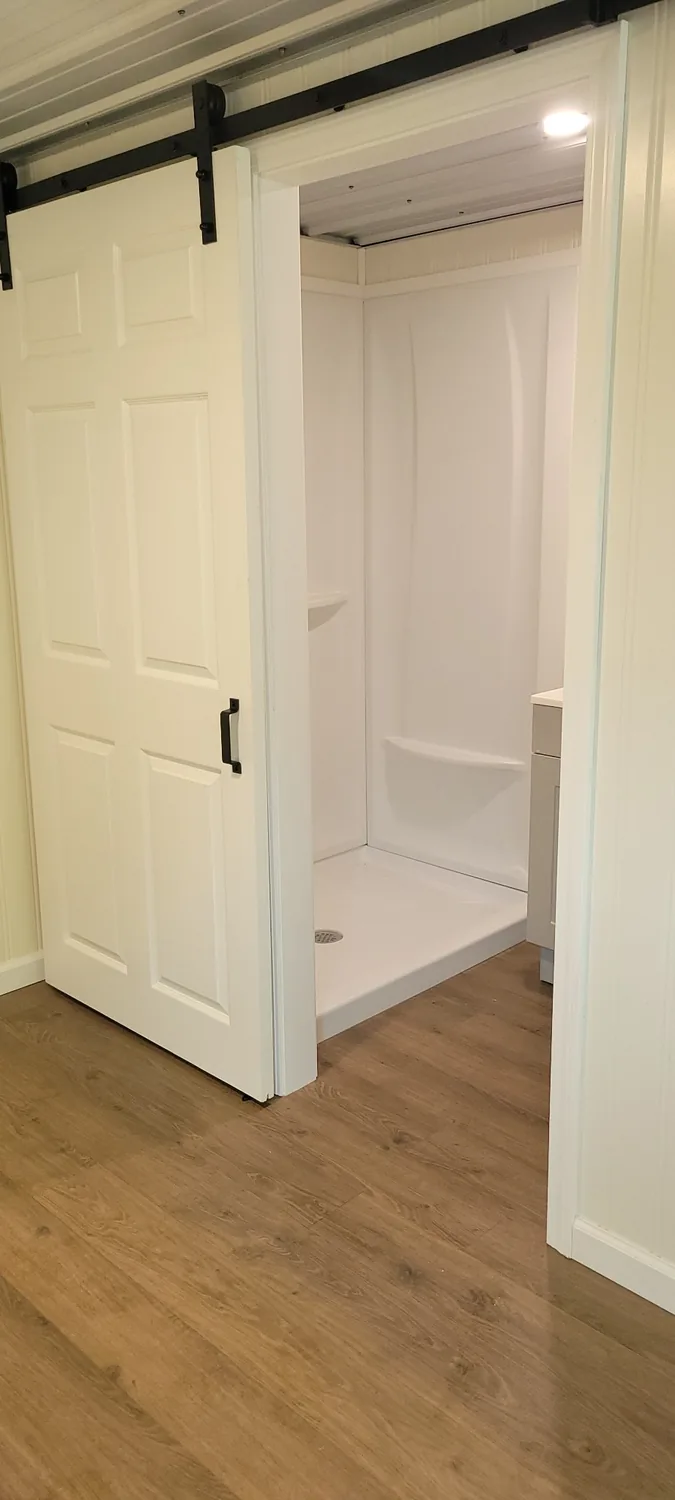 Basecamp Blue four-foot shower and sliding barn-style bathroom door