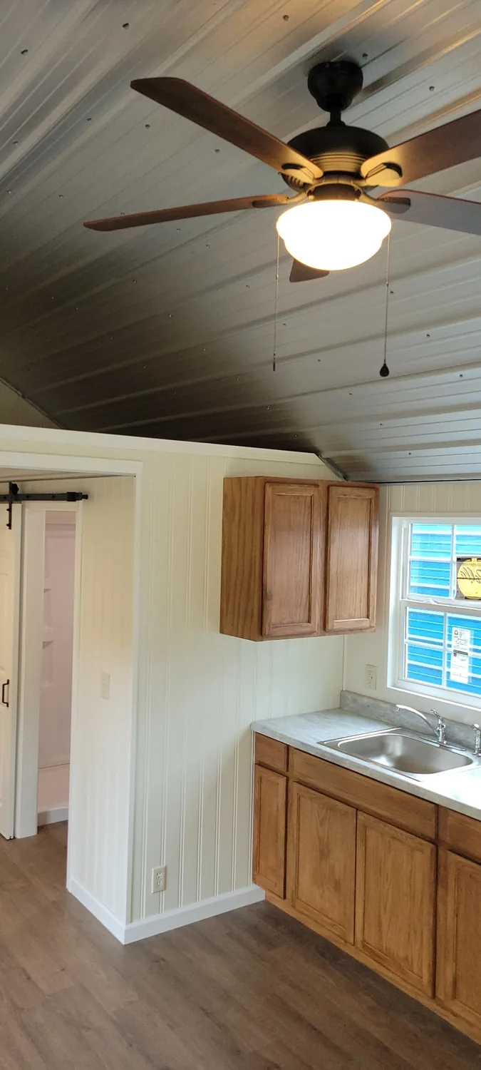 Basecamp Green ceiling fan and kitchen area