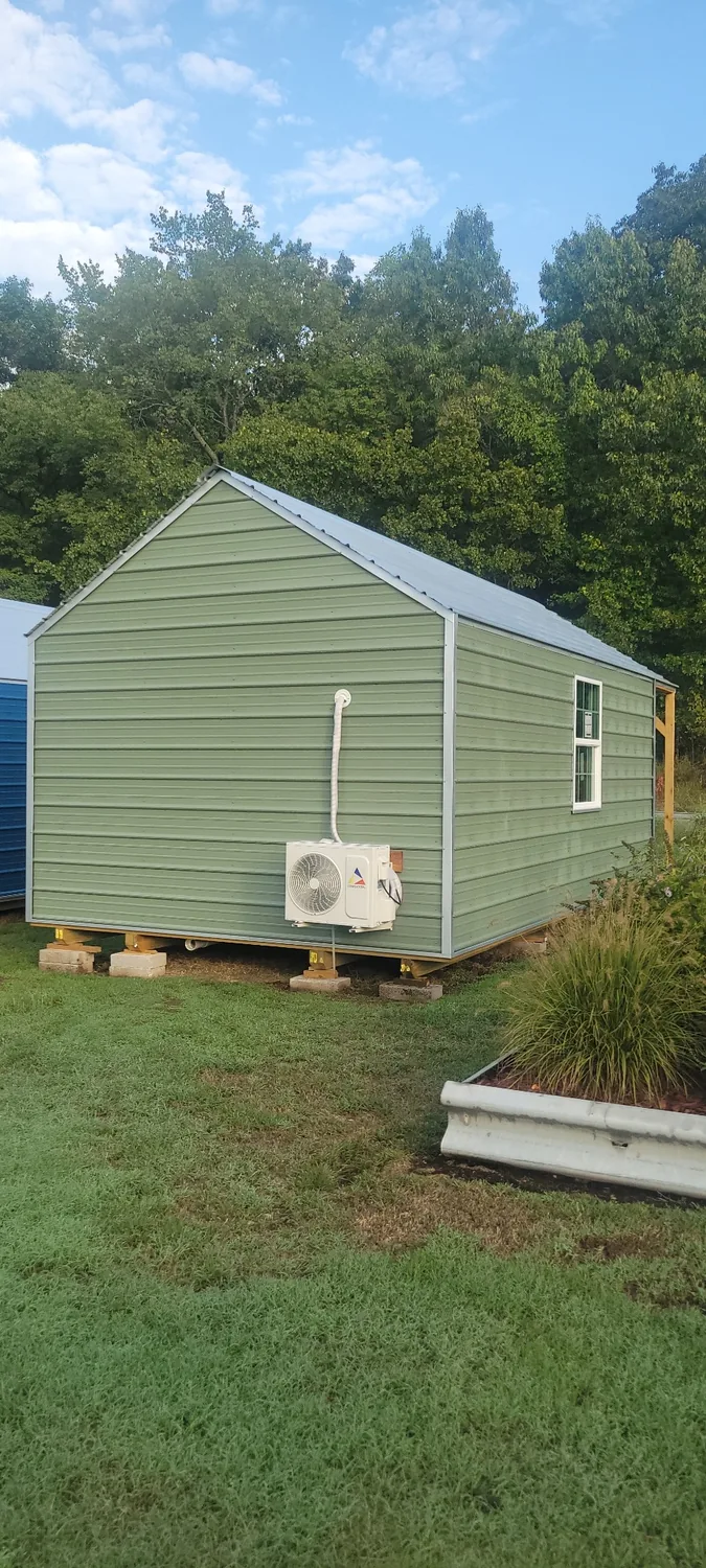 Basecamp Green rear exterior with mini-split condenser
